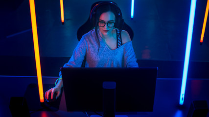 High Angle Shot of the Beautiful Friendly Pro Gamer Girl Playing in Online Video Game and Streaming...