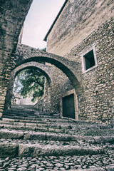 Vertical low angle view of stairs and walls of a medieval castle with white sky background.