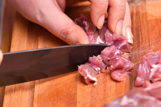 Sliced raw mutton meat. Preparation of mutton meat for cooking dinner. The knife cuts the turkey meat. Close-up