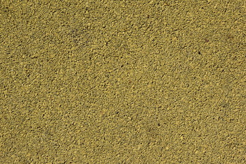 Background image of a colored rubber coating yellow. Worn sports field cover