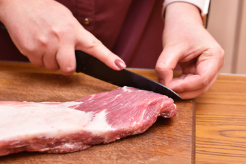 Trim excess fat from pork meat on the ribs. To remove unwanted fat on the meat