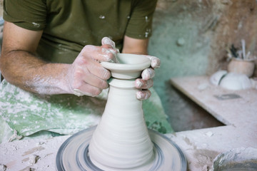 Ceramic dishes in working process. Creating ceramic pieces. Tradicional ceramic factory in spain. man working with traditional potter's wheel