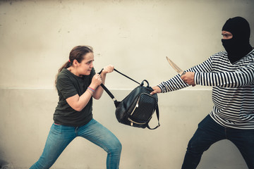 Robber man snatching bag from tourist women on the street, Thief, Robbery concept