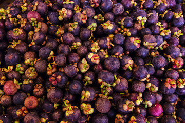 mangosteen type of tropical fresh fruits , heap of organic nutrition diet fruit at asian market in Thailand . common useful vitamin for good foods .