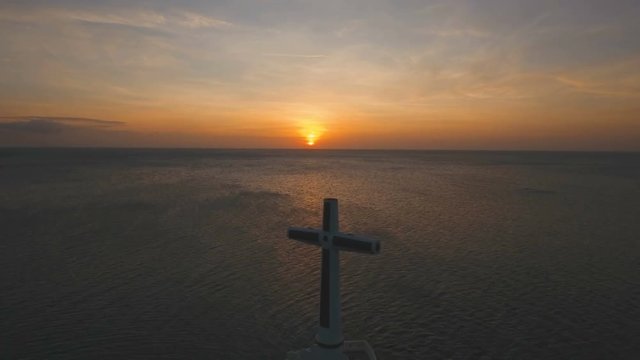 Aerial view Sunken Cemetery cross at sunset in Camiguin Island, Philippines. Large crucafix marking the underwater sunken cemetary of the coast of camiguin island near mindanao in the Philippines
