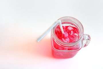 Red water and ice in clear glass