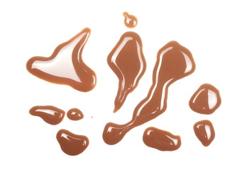 Spilled chocolate milk puddle isolated on white background, top view