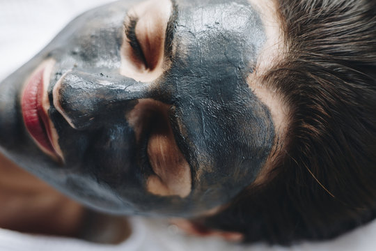 Woman relaxing with a facial mask at the spa
