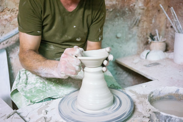 Ceramic dishes in working process. Creating ceramic pieces. Tradicional ceramic factory in spain. man working with traditional potter's wheel