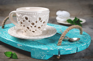 Set of ceramic tableware on a wooden tray