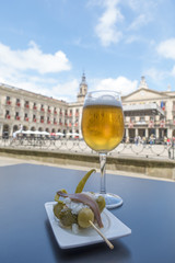Spanish tapa and beer glass.