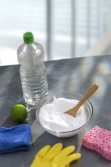Baking soda, lemon with sponge and towel for effective and safe house cleaning over larhe glass windows
