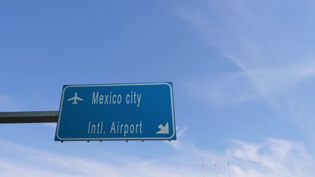 mexico city airport sign airplane passing overhead