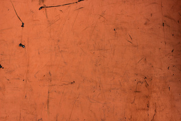 Dark orange paint plywood wall background. Dirty and scratched tera-cotta wallpaper, city building...