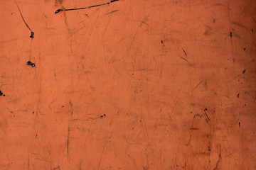 Dark orange paint plywood wall background. Dirty and scratched tera-cotta wallpaper, city building backdrop with place for text