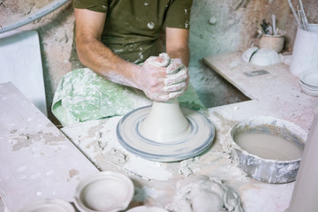 Ceramic dishes in working process. Creating ceramic pieces. Tradicional ceramic factory in spain. man working with traditional potter's wheel