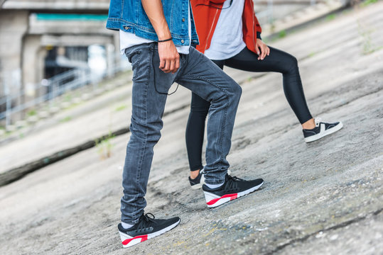 cropped image of stylish young couple standing at city street