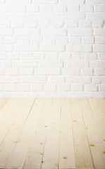 White brick wall of painted genuine clay blocks and wooden floor background
