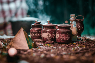 Forest Glade. old wooden cans with magical ingredients