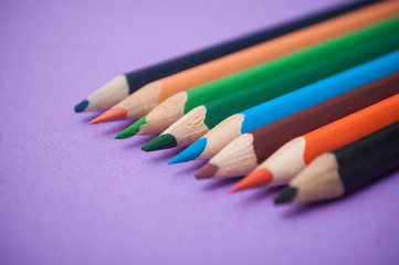 closeup of colouring pencils on color background