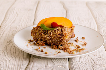Peach crumble on a blue wooden table.