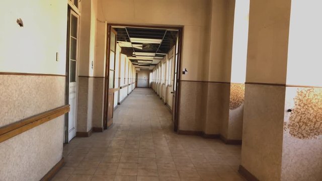 walk through abandoned and deteriorated asylum corridor