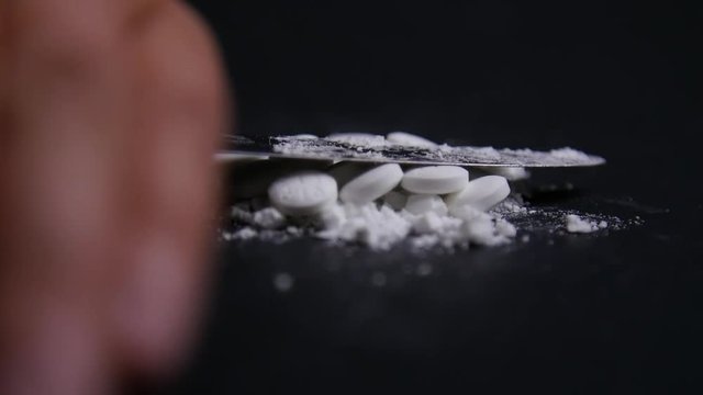 Hand Crushes Pills Into Powder in Slow Motion