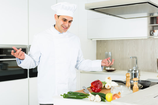Portrait of the man proffesional who is posing in the kitchen