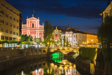 Fototapeta na wymiar Church of the Annunciation and Lublanica river at night in Ljubljana, Slovenia