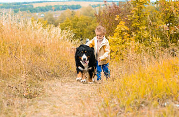 boy running around with big dog