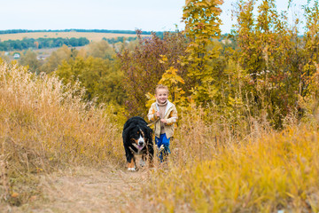 boy running around with big dog