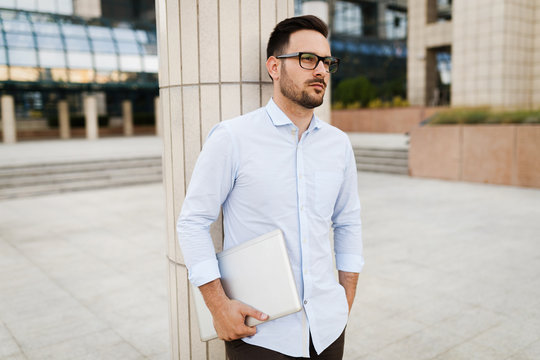 Businessman wearing glasses holding tablet