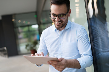 Man in white shirt using tablet