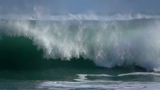 Ocean sea wave green water blue sky foam fizz slow motion