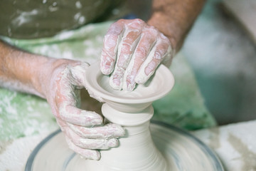 Ceramic dishes in working process. Creating ceramic pieces. Tradicional ceramic factory in spain. man working with traditional potter's wheel