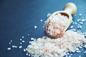 Himalayan pink salt in crystals above a gray stone