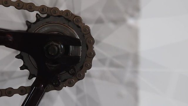 Chain and sprocket detail on a fixie style bicycle. Rotating and power transfer.
