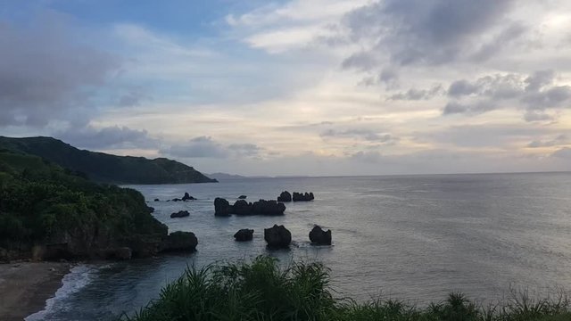 A shot of rocky shore and the ocean during sunset. Shot in Basco, Batanes.
