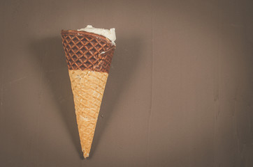 ice cream with cone in chocolate on a dark background/ice cream with cone in chocolate on a dark background, top view and copyspace