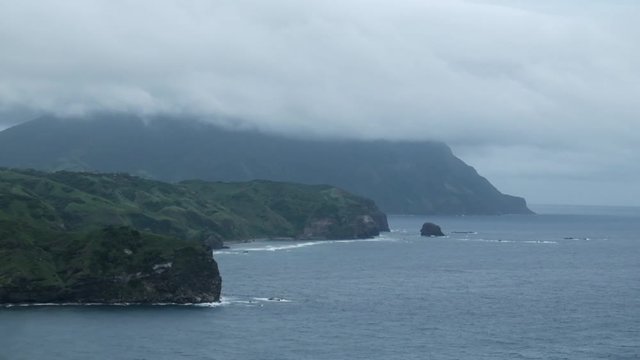 The boundary of land and the endless ocean with thick clouds hovering above. Shot in Basco, Batanes.