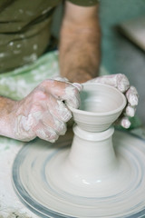 Ceramic dishes in working process. Creating ceramic pieces. Tradicional ceramic factory in spain. man working with traditional potter's wheel
