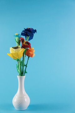 Paper flowers / origami flowers on blue background