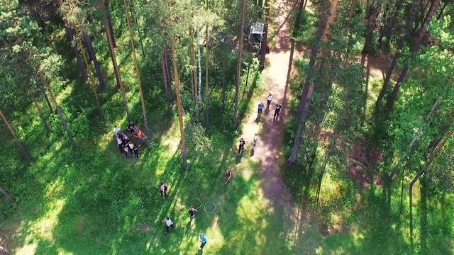 Top view of the people in the forest in the campaign. Stock. Group of athletes in the forest on a summer day