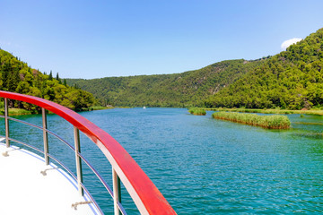 Obraz na płótnie Canvas The Krka river from an excursion ship deck at Skradin, Croatia