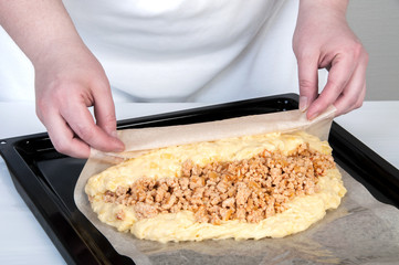 Black baking tray covered with baking paper