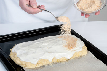 Black baking tray covered with baking paper