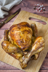 Heavily roasted grilled Chicken on wooden background