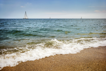 Fototapeta na wymiar three yachts in the sea with white wave