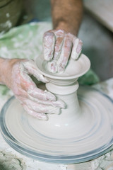 Ceramic dishes in working process. Creating ceramic pieces. Tradicional ceramic factory in spain. man working with traditional potter's wheel