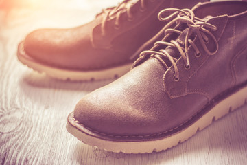 Close up vintage leather shoes man accessory. Men's casual outfits with accessories on rustic wood background,Men's accessories with brown leather shoes on wooden table